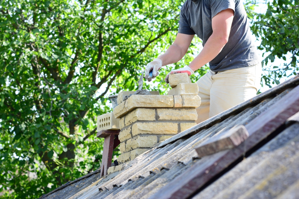 Bricklayer,Repair,Brick,Chimney,On,Asbestos,House,Rooftop