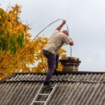 A,Male,Chimney,Sweep,Cleans,The,Chimney,From,Soot,On