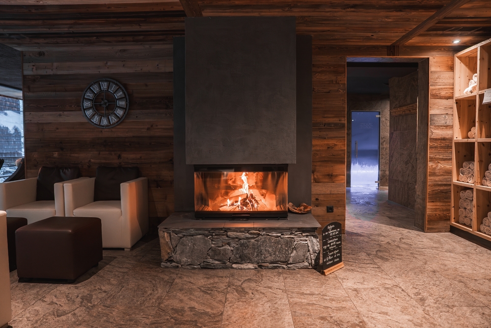 Warm,Room,With,Wooden,Walls,,Modern,Fireplace,,Armchairs,,And,Spa