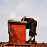 Unrecognizable,Modern,Chimney,Sweep,Checking,Out,The,Chimney,From,The